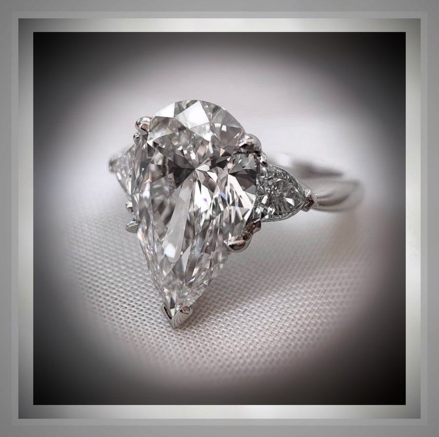 4.01 Carat Three Stone Pear Shaped Diamond Engagement Ring With Pear Diamond side stones